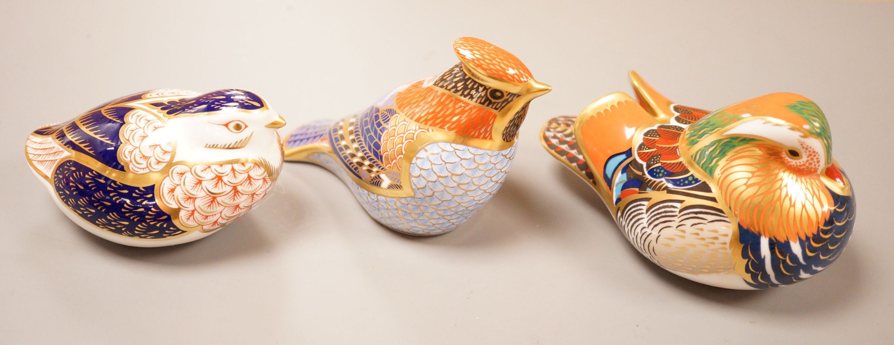 Three Royal Crown Derby Imari paperweights; a duck and two birds, silver badge